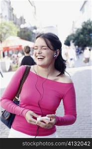 Young woman holding an MP3 player