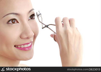 Young woman holding blush brush, portrait