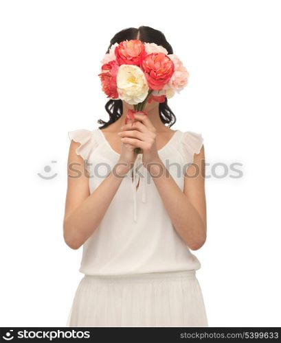 young woman holding bouquet of flowers over her face