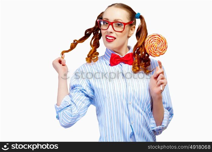 Young woman holding candy. Image of young funny woman in red glasses holding candy