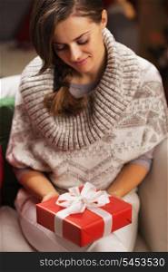 Young woman holding christmas present box