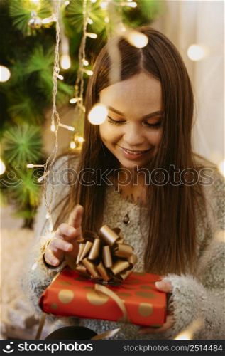 young woman holding christmas tree