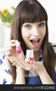Young Woman Holding Colorful Bottles Of Nail Polish