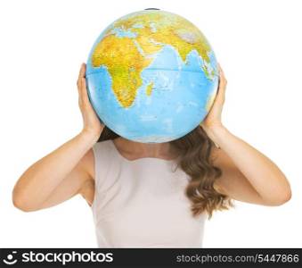 Young woman holding earth globe in front of face