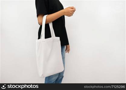 young woman holding eco cotton bag isolate on white background