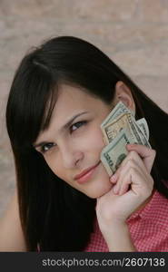 Young woman holding Euro notes in her hands