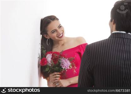 Young woman holding flower bouquet standing with her boyfriend