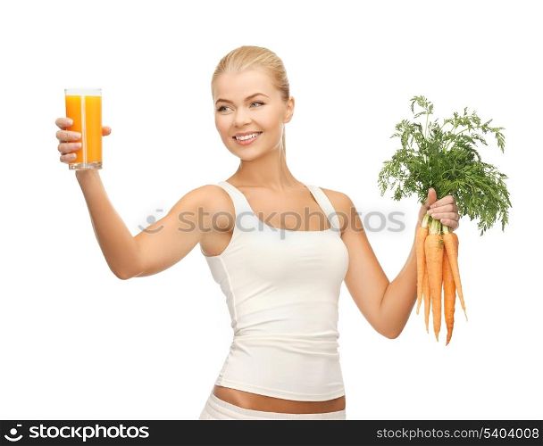 young woman holding glass of juice and carrots