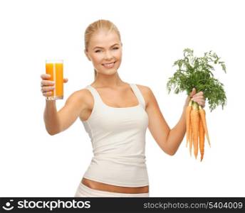 young woman holding glass of juice and carrots