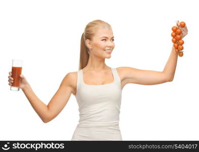 young woman holding glass of juice and tomatoes