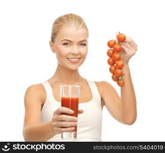 young woman holding glass of juice and tomatoes