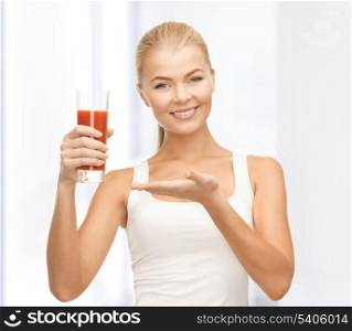 young woman holding glass of tomato juice