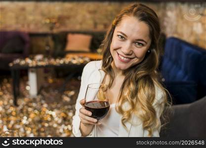 young woman holding glass red wine bar