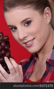 Young woman holding grapes