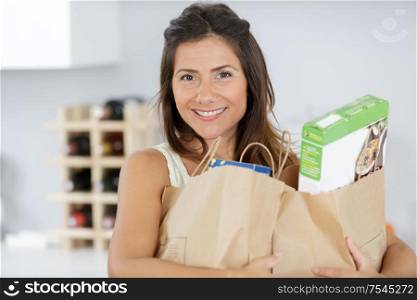 young woman holding grocery shopping bag