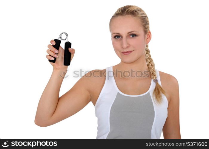 Young woman holding hand grippers