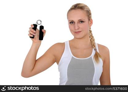 Young woman holding hand grippers