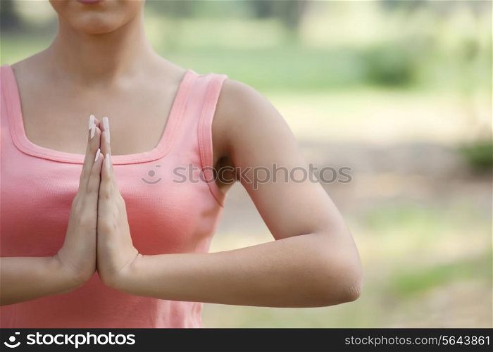 Young woman holding hands in prayer position