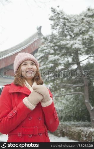Young Woman Holding hands in snow