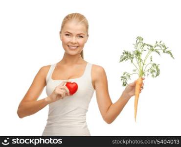 young woman holding heart symbol and carrot