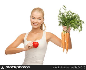 young woman holding heart symbol and carrots