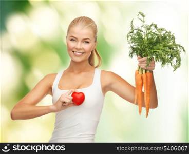 young woman holding heart symbol and carrots