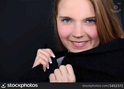 Young woman holding her collar