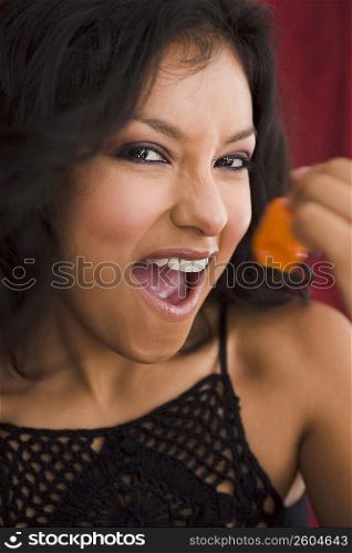 Young woman holding hot pepper
