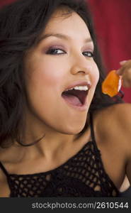 Young woman holding hot pepper