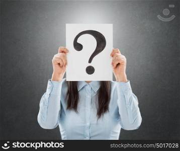 Young woman holding interrogation symbol in front of her face