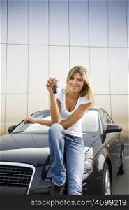 Young woman holding keys to new car