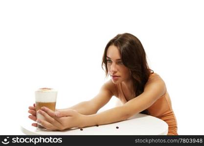 young woman holding latte macchiato coffee at the other side of the table. young woman holding latte macchiato coffee at the other side of the table on white background