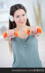 Young woman holding light weights