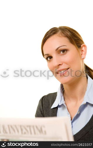 Young woman holding newspaper, smiling, portrait