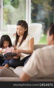 Young Woman Holding Page of Coloring Book for Daughter