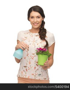 young woman holding pot with flower and spray bottle