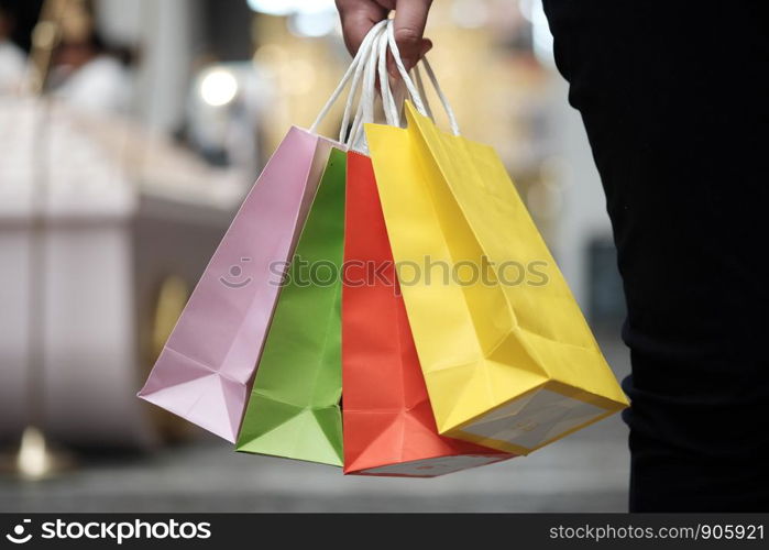 Young woman holding sale shopping bags. consumerism lifestyle concept in the shopping mall