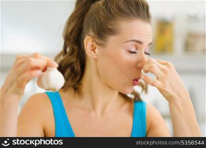 Young woman holding smelly garlic