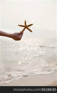 Young Woman Holding Starfish