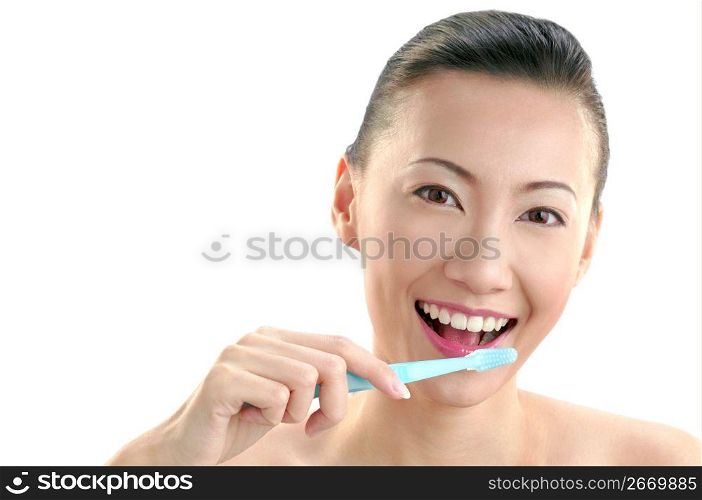 Young woman holding tooth brush, portrait