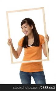 Young woman holding wooden frame, portrait