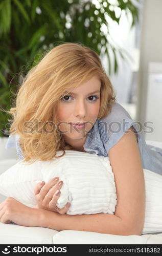 Young woman hugging a pillow