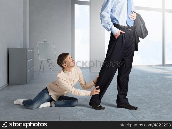 Young woman hugging husbands leg and asking not to go