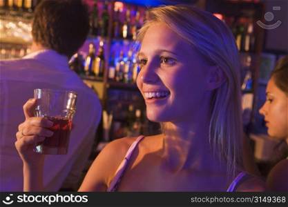 Young woman in a bar with friends