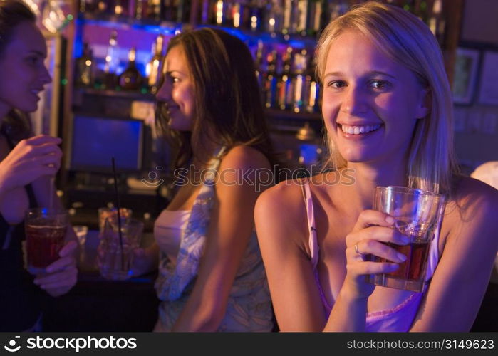 Young woman in a bar with friends