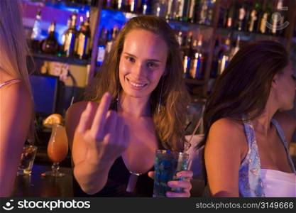 Young woman in a bar with friends