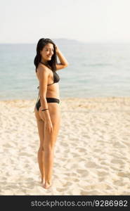 Young woman in a bikini posing at the beach