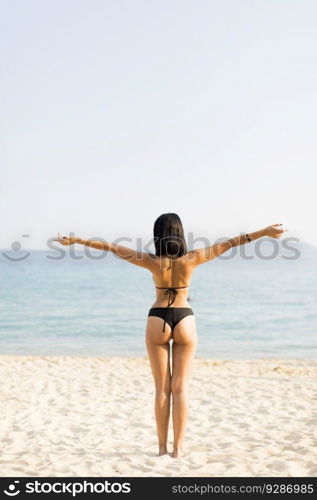 Young woman in a bikini posing at the beach