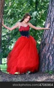 Young woman in a red gothic dress