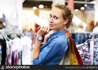 Young woman in a shop buying clothes